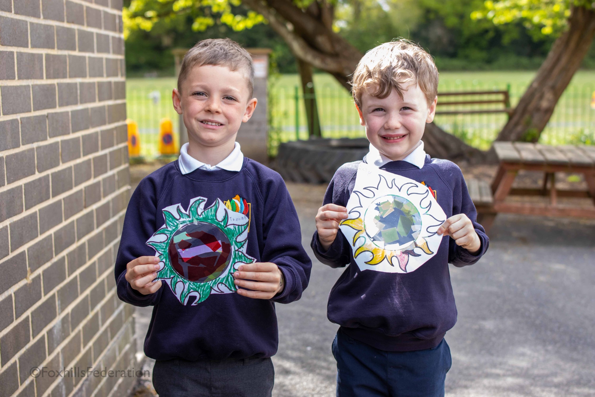 Two boy hold their suncatchers