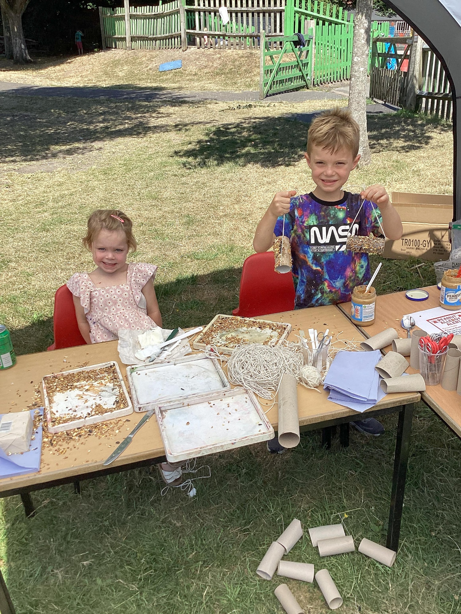 Two children smile as they help out with the Foxhills Freshen-up