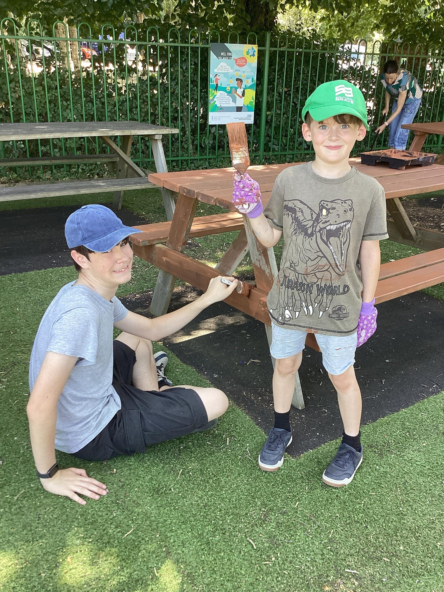 Two children smile as they help out with the Foxhills Freshen-up