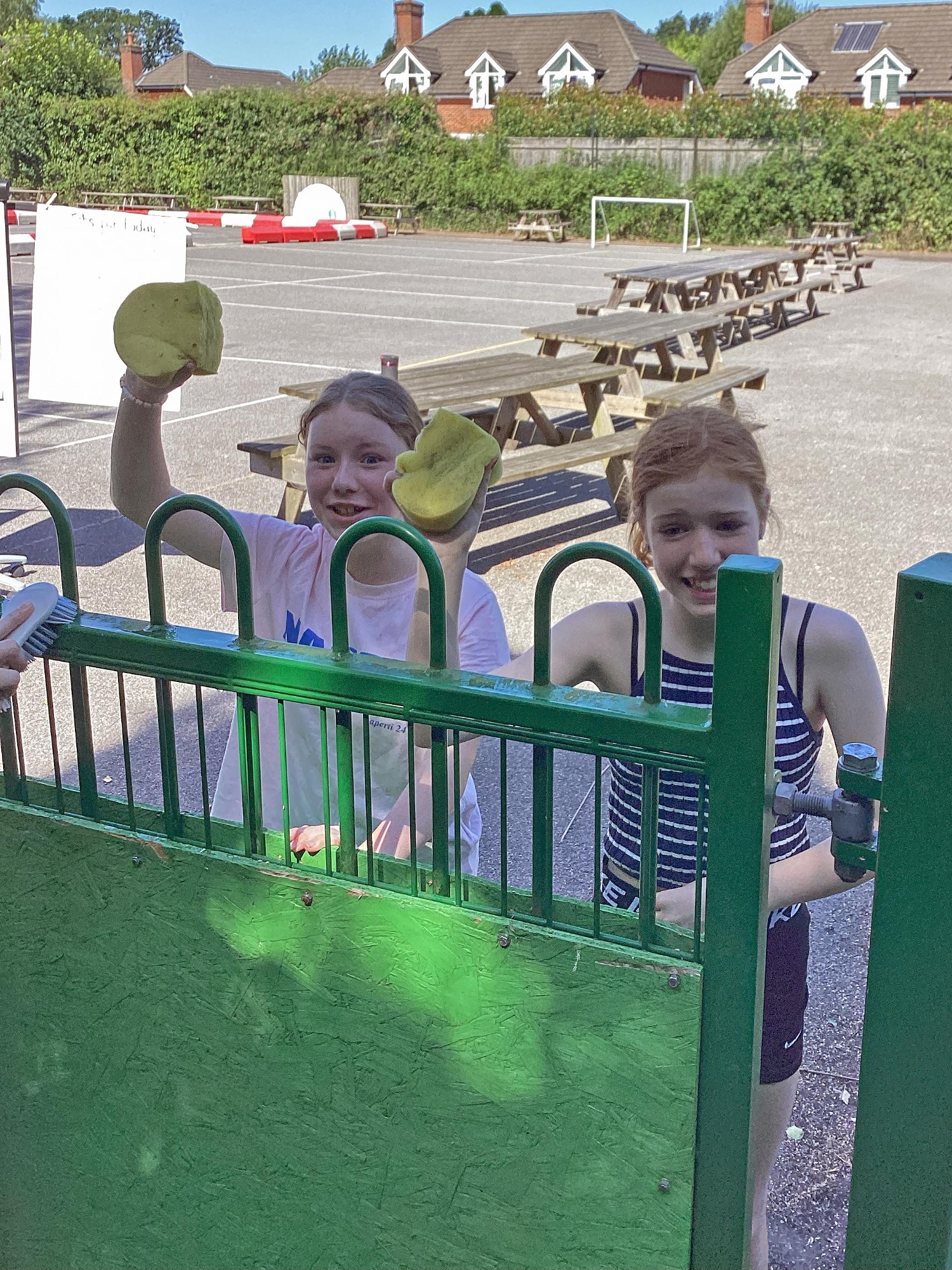 Two children smile as they help out with the Foxhills Freshen-up
