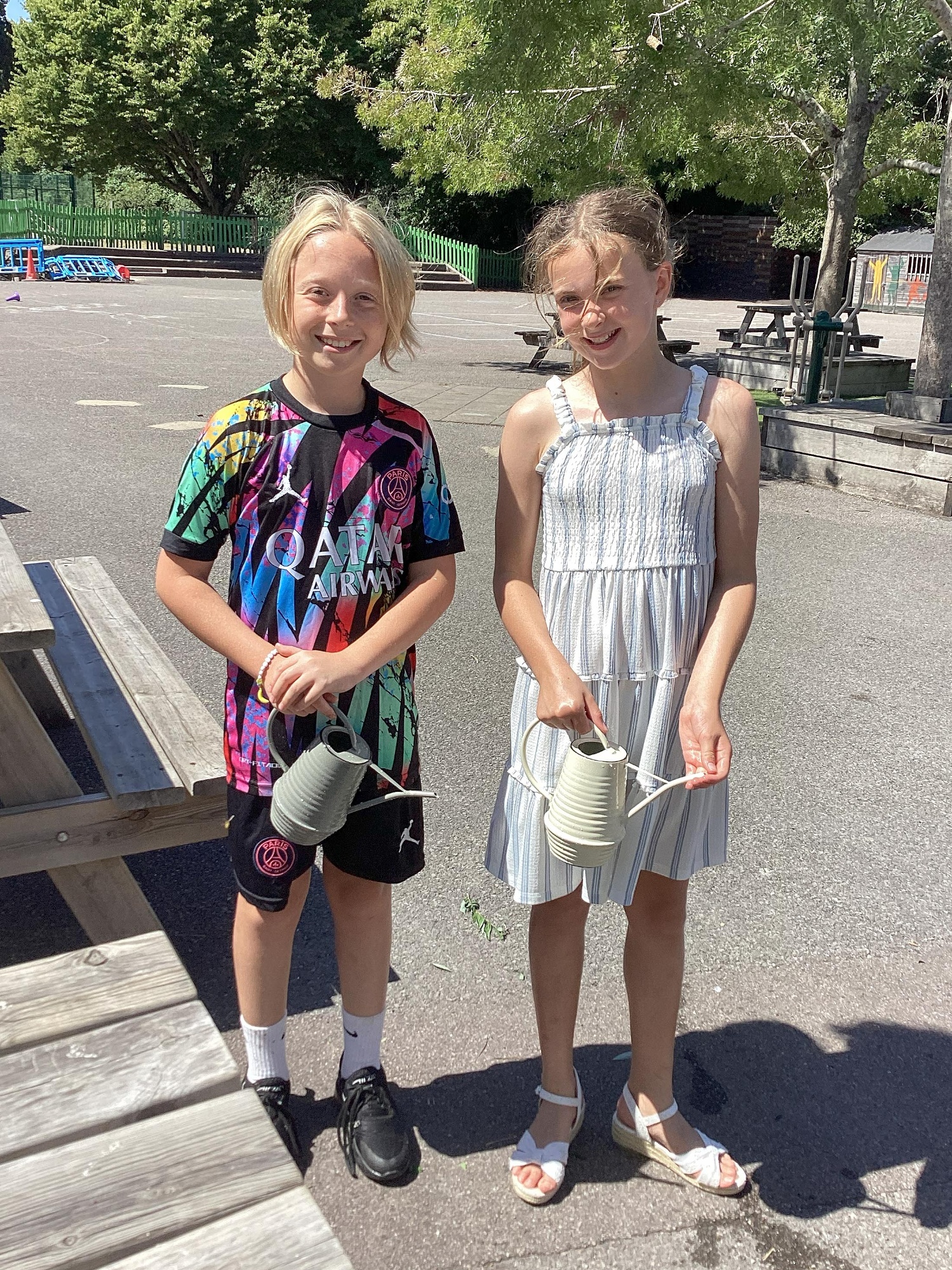 Two children smile as they help out with the Foxhills Freshen-up