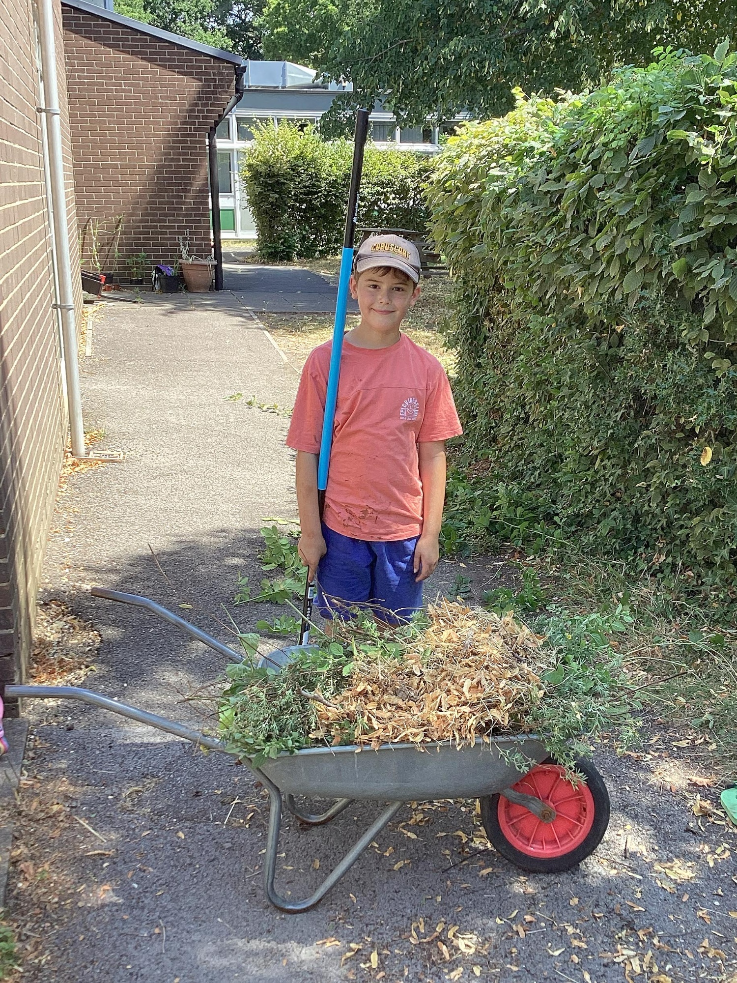 A boy helps out in the school garden