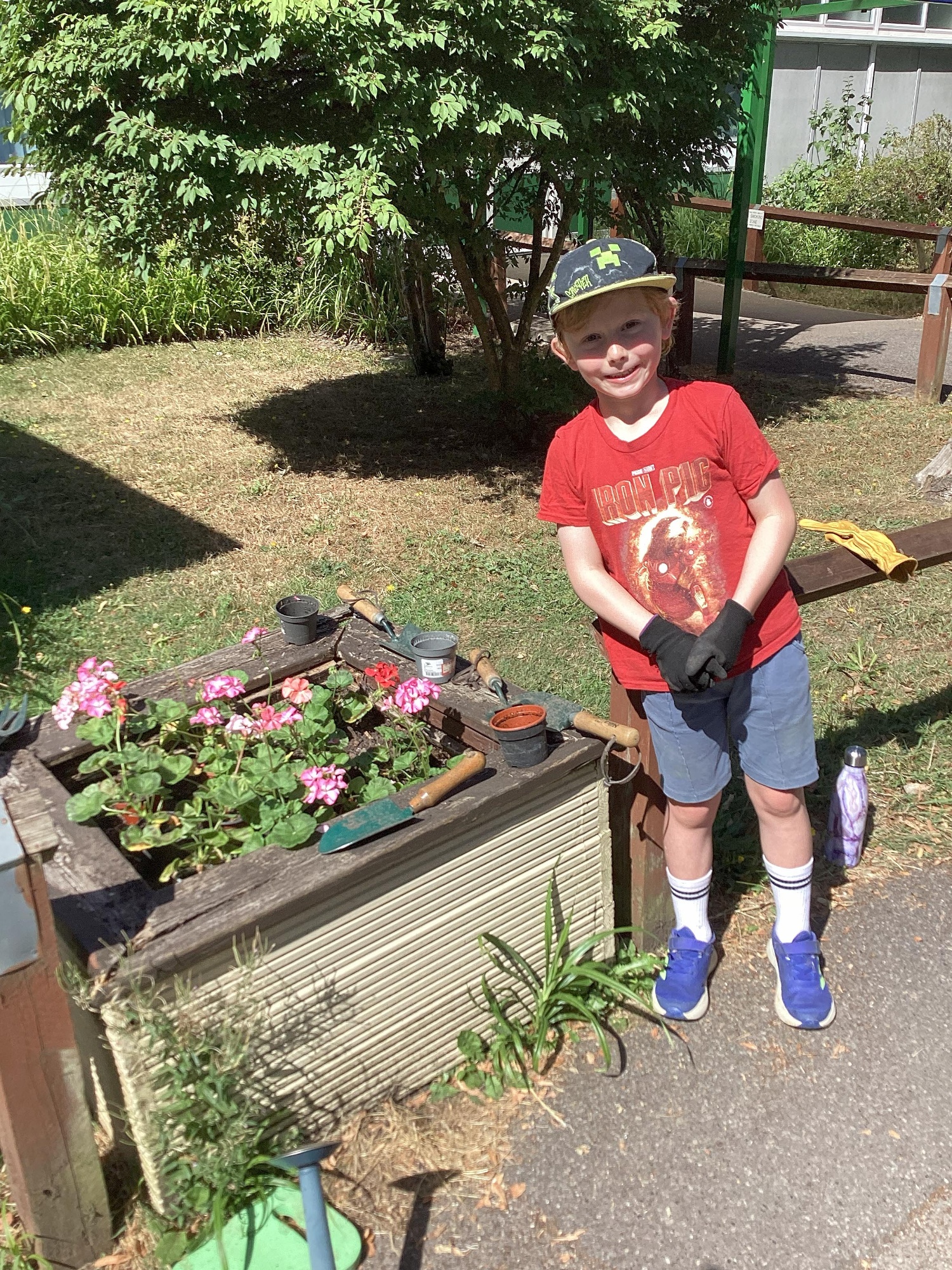 A boy plants new flowers