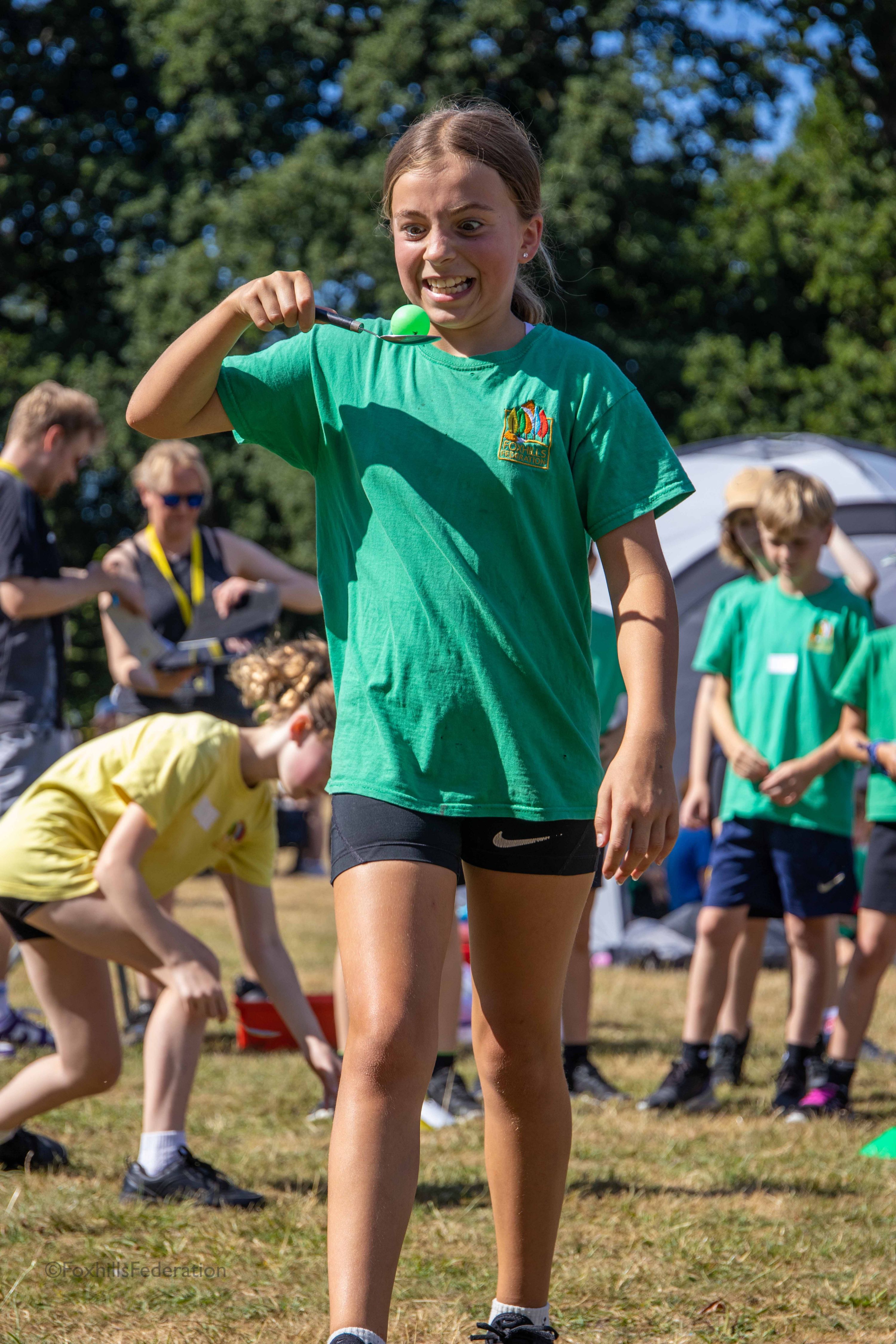A girl hold an egg and spoon