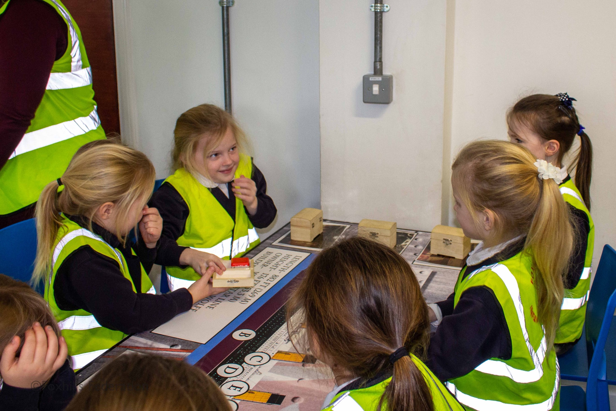 Children gather around objects from the SeaCity museum.