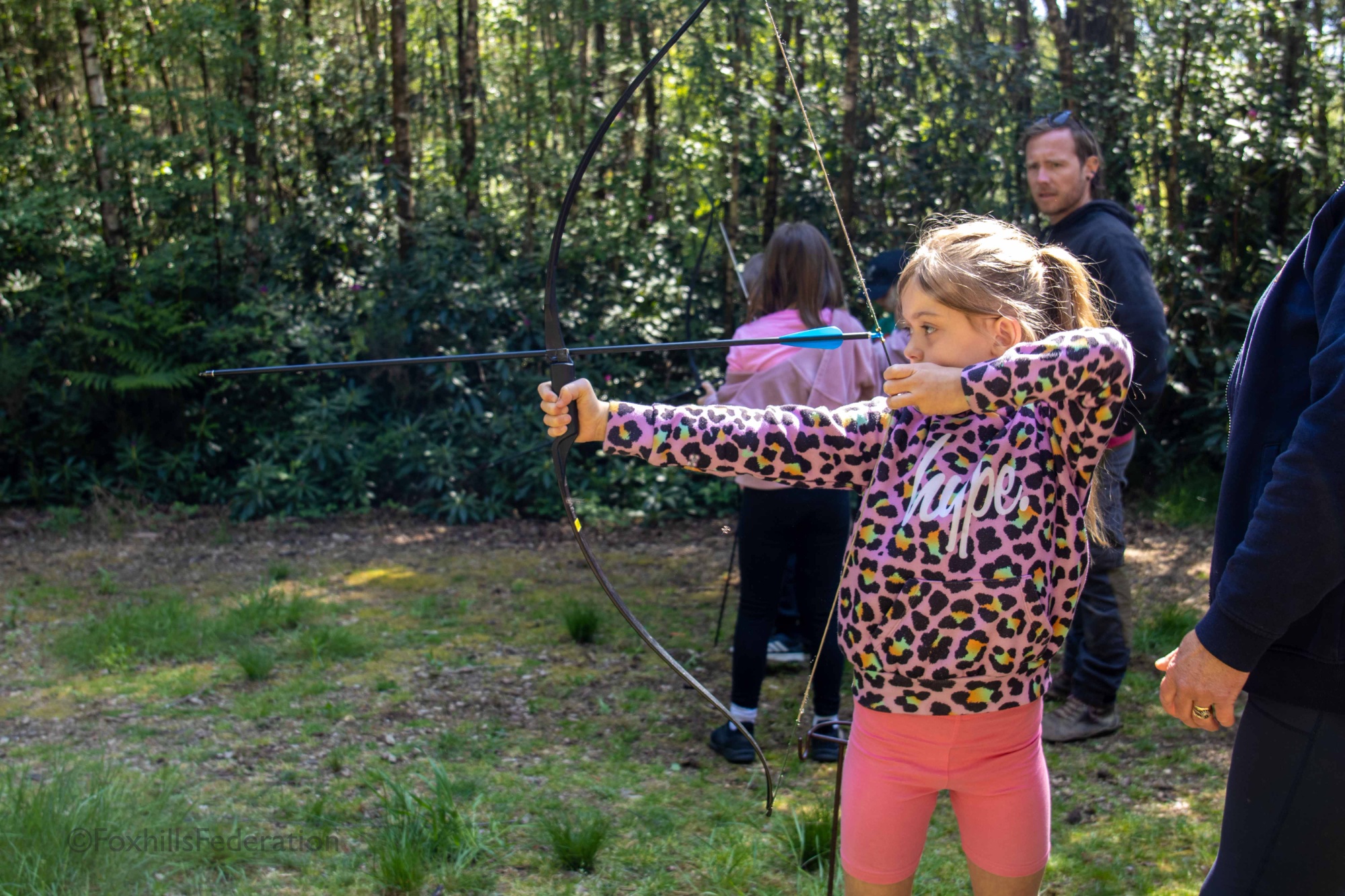 A girl fires an arrow