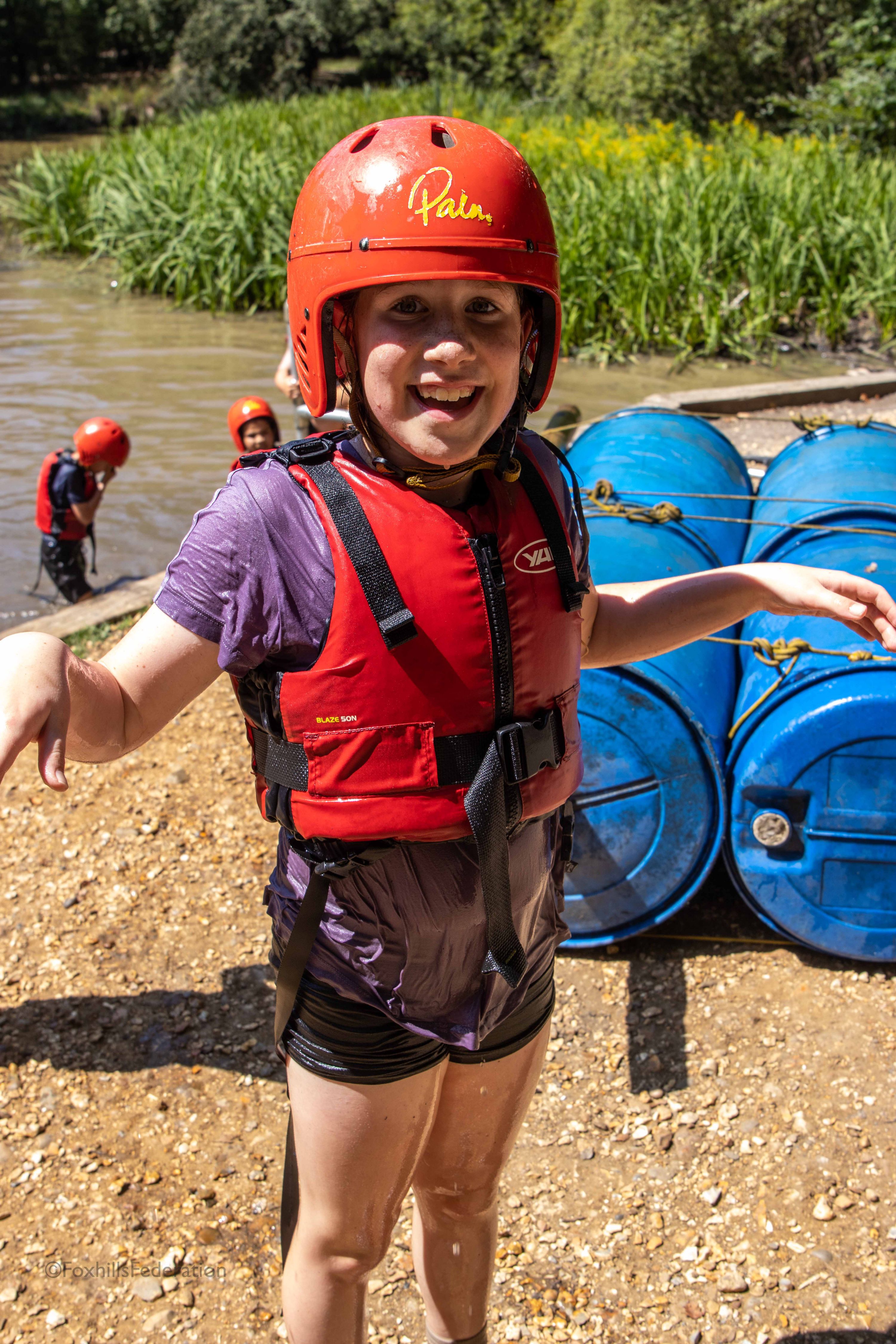 A girl smiles after raft building